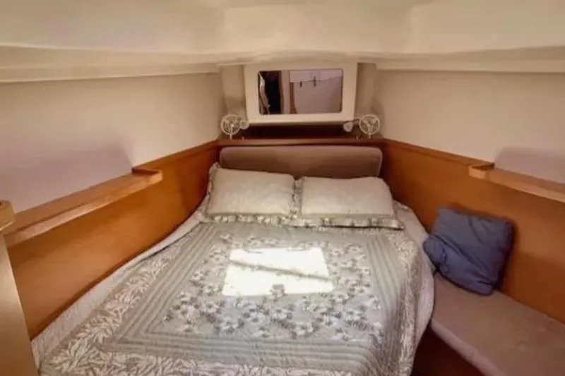 Slide: The Image of Cozy cabin interior of 2007 Hanse 400 yacht with double bed and wooden accents. - 19