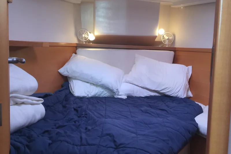 Slide: The Image of Cozy cabin interior of 2007 Hanse 400 yacht with blue bedding and pillows. - 20