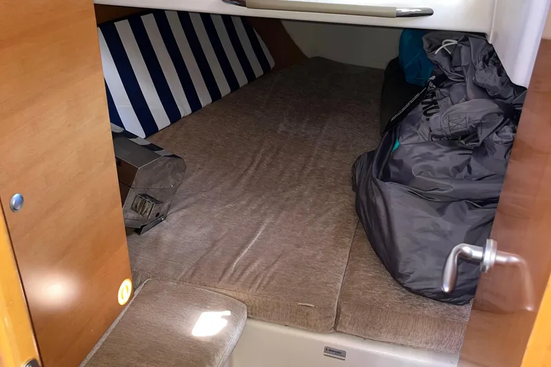 Slide: The Image of Cozy cabin interior of 2007 Hanse 400 sailboat with striped cushions and storage. - 21