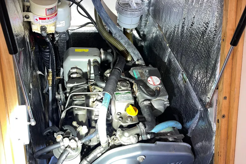 Slide: The Image of Engine compartment of a 2007 Hanse 400 sailboat, showcasing mechanical components and insulation. - 25