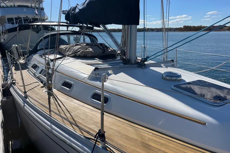 Slide: The Image of 2007 Hanse 400 sailboat docked, featuring sleek design and wooden deck. - 27