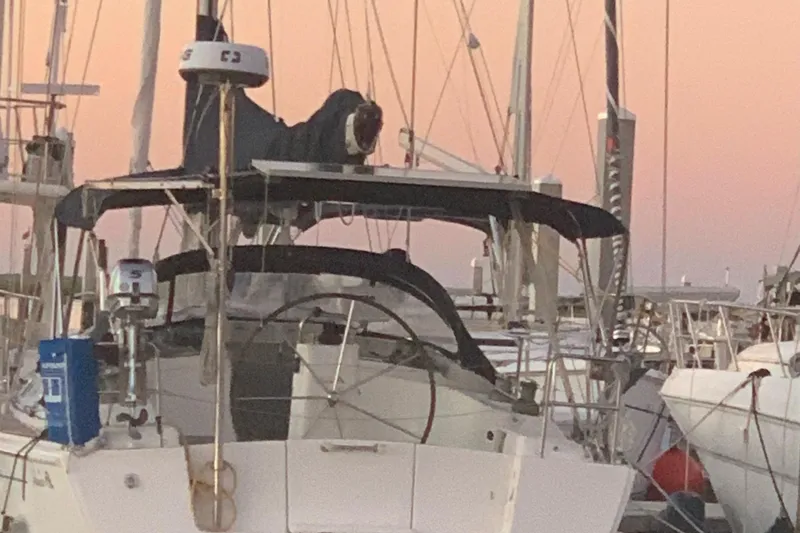 Slide: The Image of Sailboat Hanse 400, 2007 model, docked at sunset with visible steering wheel and canopy. - 4