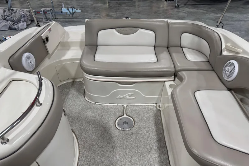 Slide: The Image of 2004 Sea Ray 270 Sundeck interior with cushioned seating and speakers. - 11