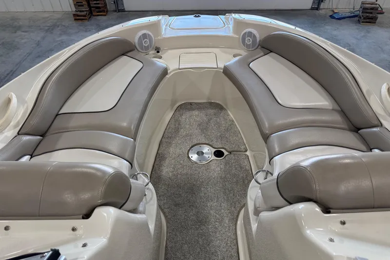 Slide: The Image of 2004 Sea Ray 270 Sundeck interior with beige seating and carpeted floor. - 13
