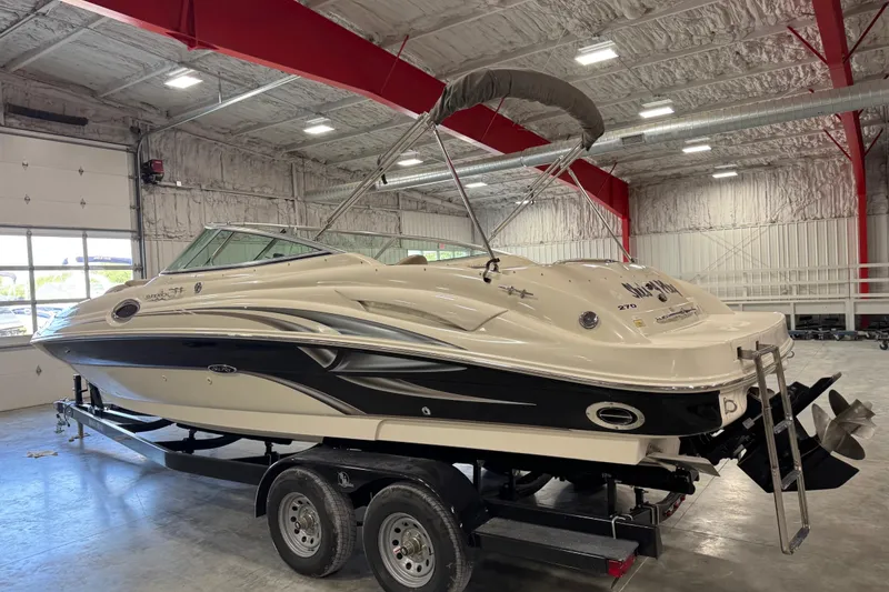 Slide: The Image of 2004 Sea Ray 270 Sundeck boat on trailer in indoor storage facility. - 4