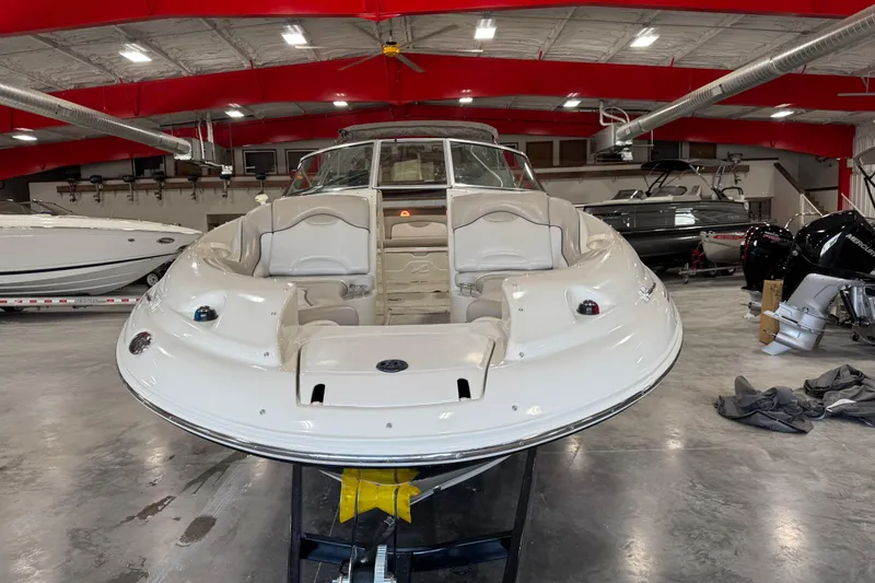 Slide: The Image of 2004 Sea Ray 270 Sundeck boat in a showroom with red ceiling beams. - 6