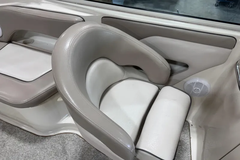 Slide: The Image of 2004 Sea Ray 270 Sundeck interior with beige seating and built-in speaker. - 8