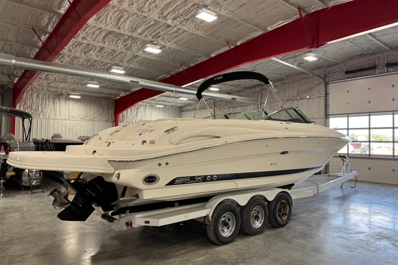 Slide: The Image of 2005 Sea Ray 290 SLX boat on trailer in indoor storage facility. - 3