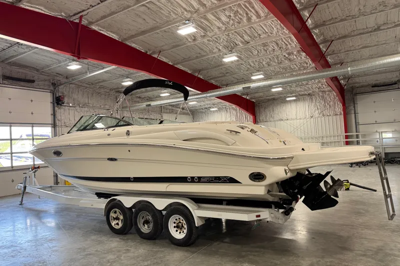 Slide: The Image of 2005 Sea Ray 290 SLX boat on trailer in indoor storage facility. - 4