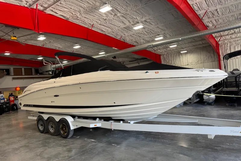 Slide: The Image of 2005 Sea Ray 290 SLX boat on trailer in indoor storage facility. - 6