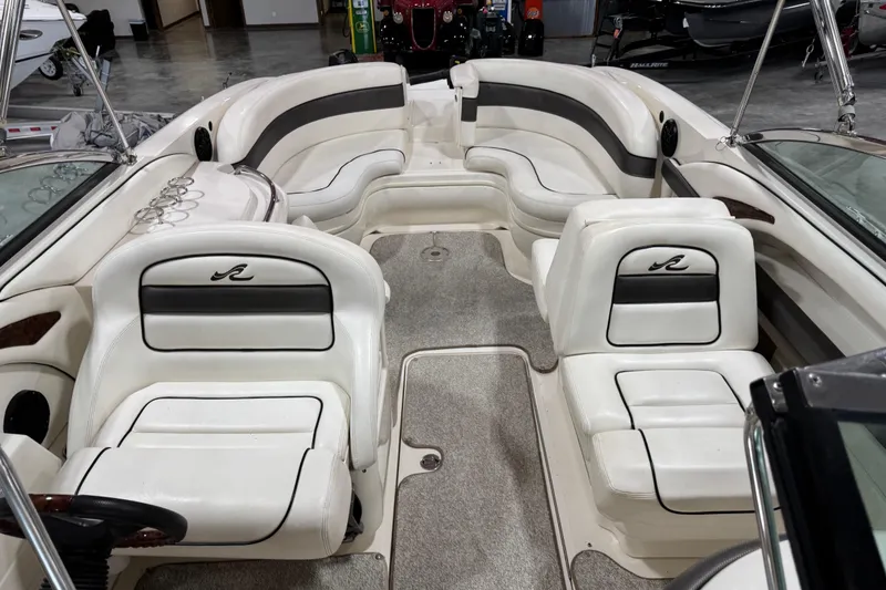 Slide: The Image of 2005 Sea Ray 290 SLX boat interior with white seating and gray carpet. - 7