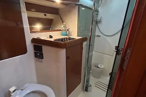 Slide: The Image of 2005 Jeanneau Deck Salon 43 bathroom with sink, toilet, and shower. - 24