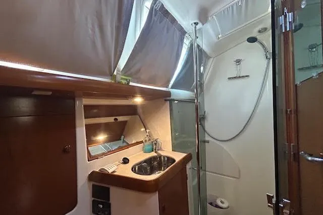 Slide: The Image of Luxurious bathroom in 2005 Jeanneau Deck Salon 43 yacht with modern fixtures and shower. - 28
