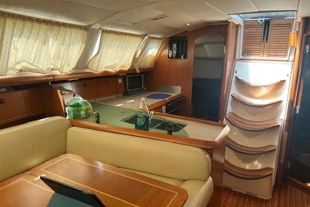 Slide: The Image of Interior of 2005 Jeanneau Deck Salon 43 yacht with kitchen and seating area. - 35