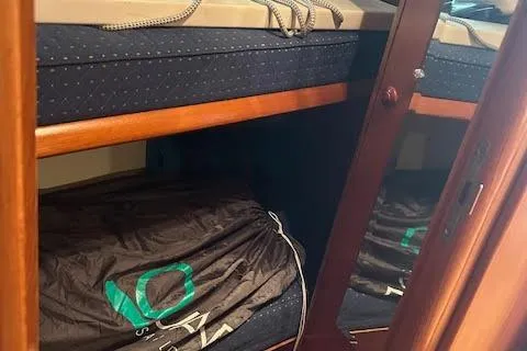 Slide: The Image of 2005 Jeanneau Deck Salon 43 interior with wooden cabinetry and storage space. - 36