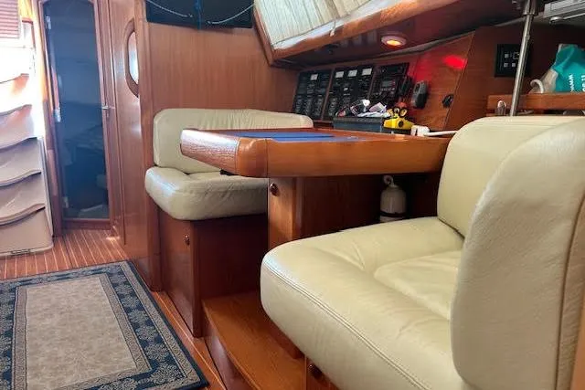 Slide: The Image of Interior of 2005 Jeanneau Deck Salon 43 with seating and navigation panel. - 37