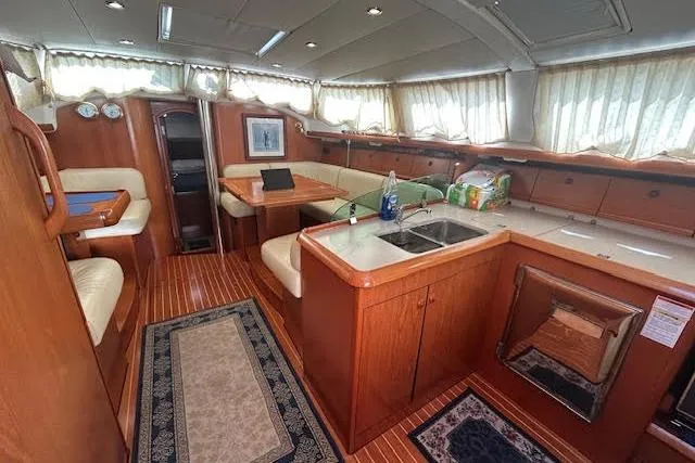 Slide: The Image of Interior of 2005 Jeanneau Deck Salon 43 yacht with wood finish and spacious seating. - 39