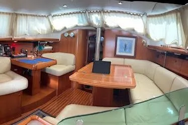 Slide: The Image of Interior of 2005 Jeanneau Deck Salon 43, featuring elegant seating and wooden finishes. - 41