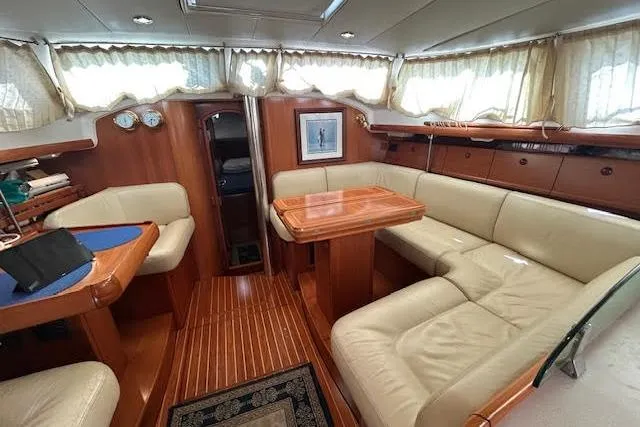 Slide: The Image of Luxurious interior of 2005 Jeanneau Deck Salon 43 with elegant wood and leather seating. - 45