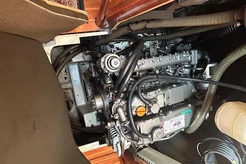 Slide: The Image of Engine compartment of a 2005 Jeanneau Deck Salon 43 sailboat, showcasing mechanical components. - 49