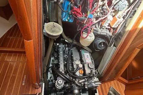 Slide: The Image of Engine compartment of a 2005 Jeanneau Deck Salon 43 sailboat, showcasing detailed mechanical components. - 51