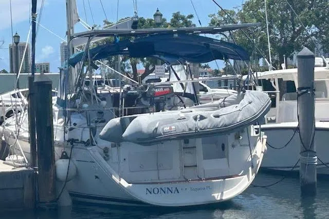 Slide: The Image of 2005 Jeanneau Deck Salon 43 sailboat docked at marina, rear view. - 9