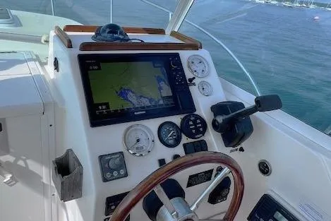 Slide: The Image of 2004 Hunt Yachts Surfhunter 25 helm with navigation system and steering wheel. - 11