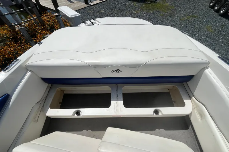 Slide: The Image of 2013 Monterey 184FS boat interior with white and blue seating and storage compartments. - 10