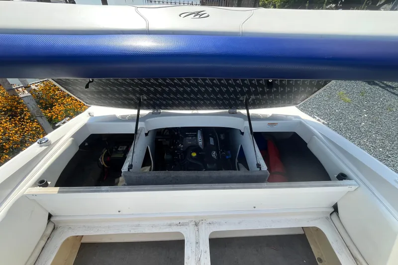Slide: The Image of Open engine compartment of 2013 Monterey 184FS boat, showcasing interior components. - 11