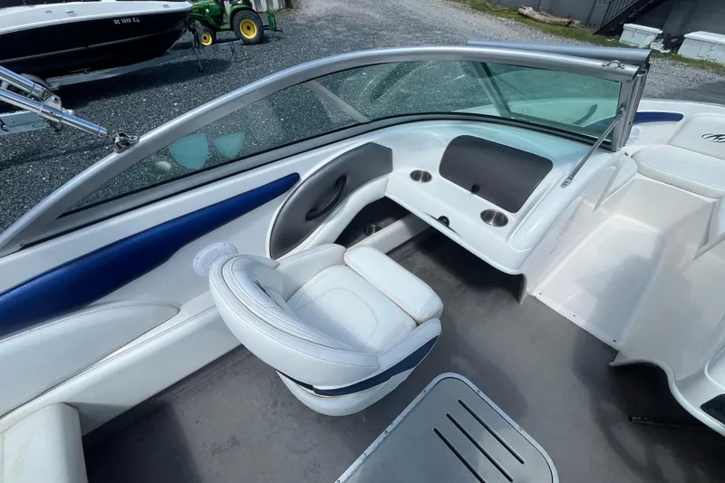 Slide: The Image of 2013 Monterey 184FS boat interior with white seating and dashboard view. - 16