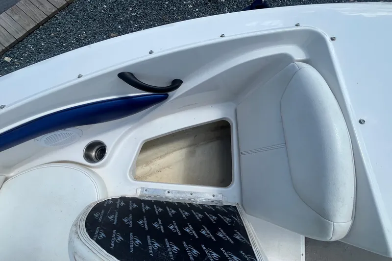 Slide: The Image of 2013 Monterey 184FS boat interior with storage compartment and cushioned seating. - 20