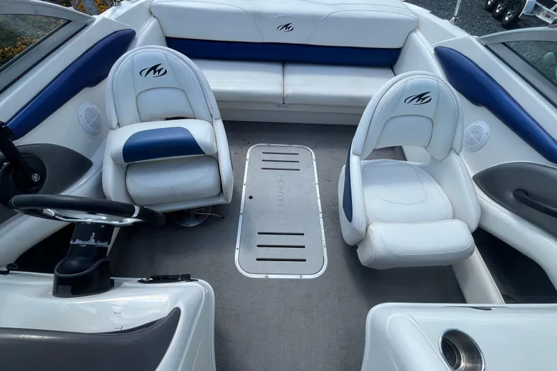 Slide: The Image of Interior of a 2013 Monterey 184FS boat with white and blue seating. - 22