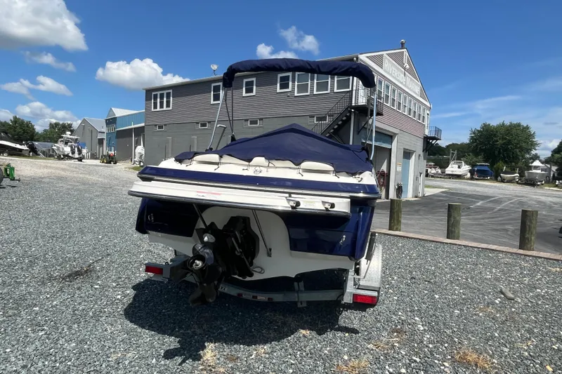 Slide: The Image of 2013 Monterey 184FS boat on trailer at marina, clear sky background. - 4