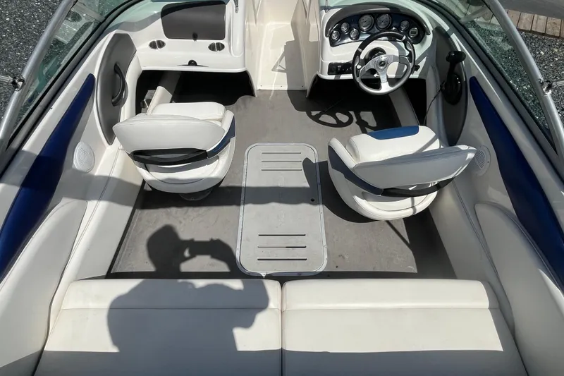 Slide: The Image of 2013 Monterey 184FS boat interior with white seating and steering console. - 8