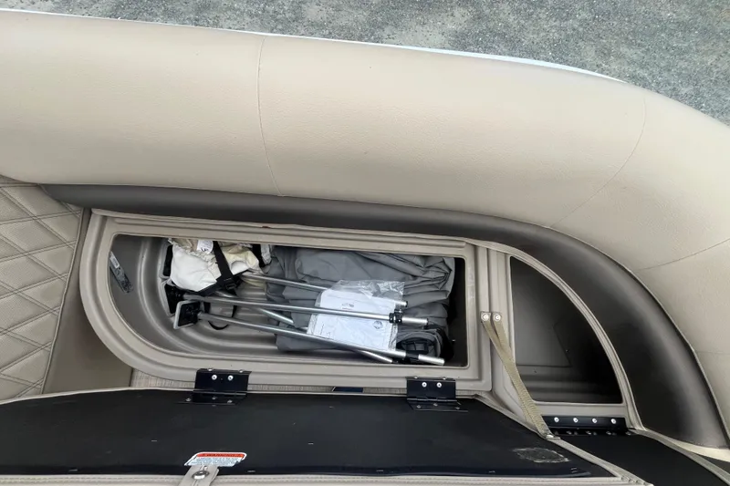 Slide: The Image of Storage compartment in 2021 Sun Tracker Party Barge 18 DLX pontoon boat, open with items inside. - 10