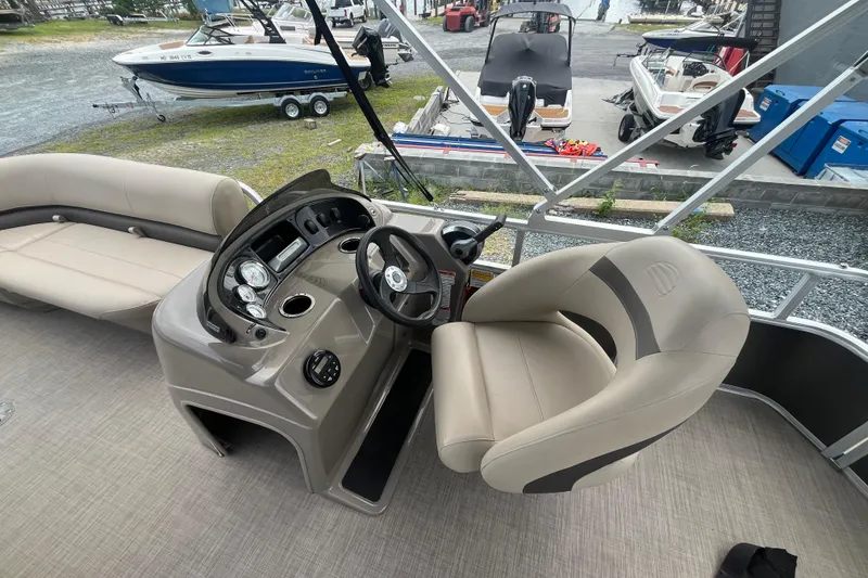 Slide: The Image of 2021 Sun Tracker Party Barge 18 DLX interior with steering console and seating. - 11