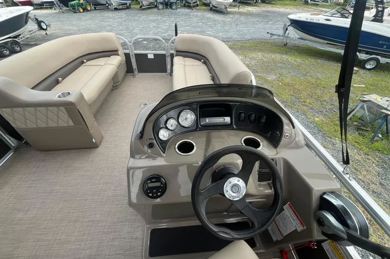 Slide: The Image of 2021 Sun Tracker Party Barge 18 DLX interior with steering console and seating. - 12