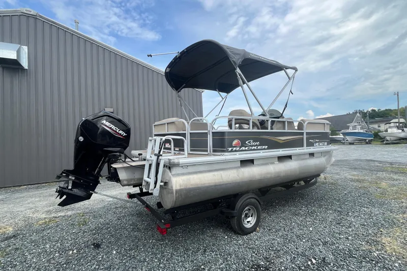 Slide: The Image of 2021 Sun Tracker Party Barge 18 DLX pontoon boat with Mercury outboard motor. - 2
