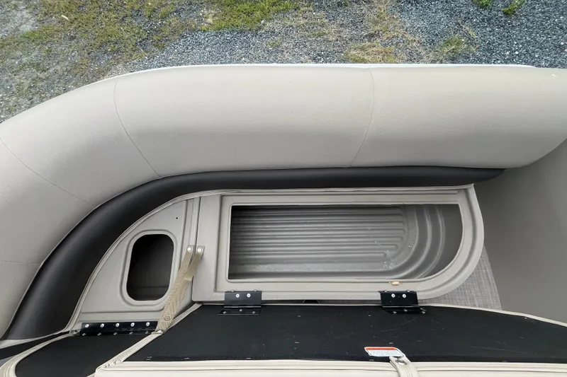 Slide: The Image of 2021 Sun Tracker Party Barge 18 DLX storage compartment with cushioned seating. - 5