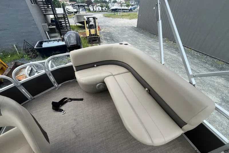 Slide: The Image of 2021 Sun Tracker Party Barge 18 DLX pontoon boat with beige seating and outdoor setting. - 7