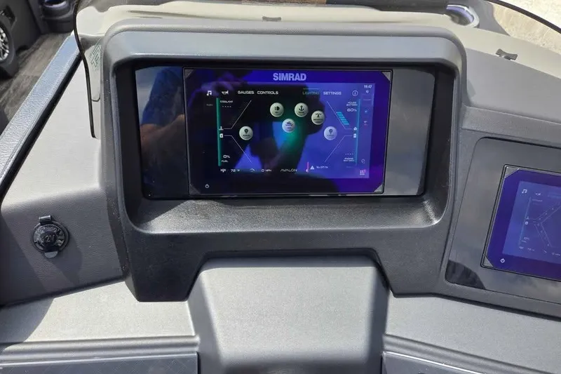 Slide: The Image of Dashboard of 2025 Avalon Catalina QUAD LOUNGER SHIFT with Simrad display screen. - 10