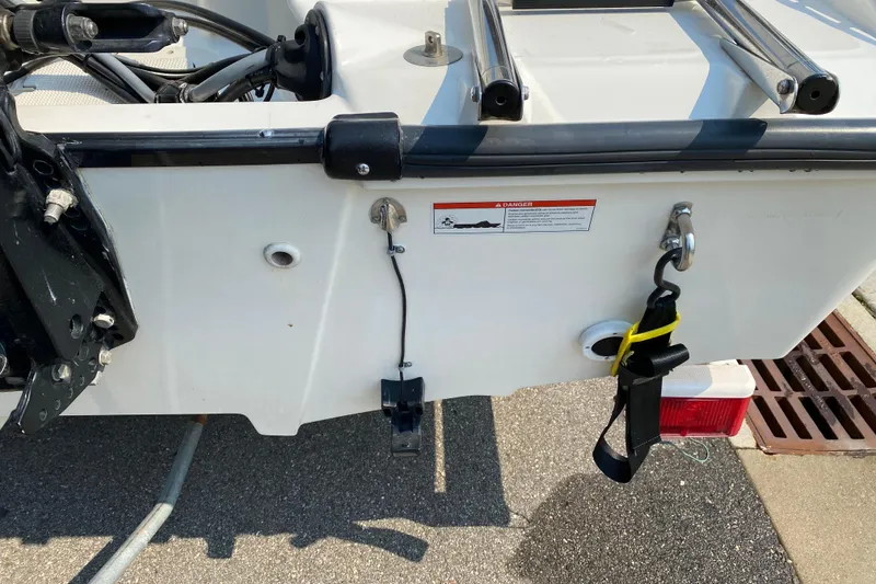 Slide: The Image of 2001 Boston Whaler 18 Dauntless boat transom with hardware and warning label. - 10