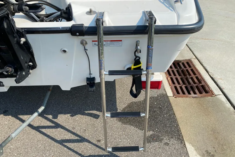 Slide: The Image of Rear view of 2001 Boston Whaler 18 Dauntless with ladder and motor components. - 11