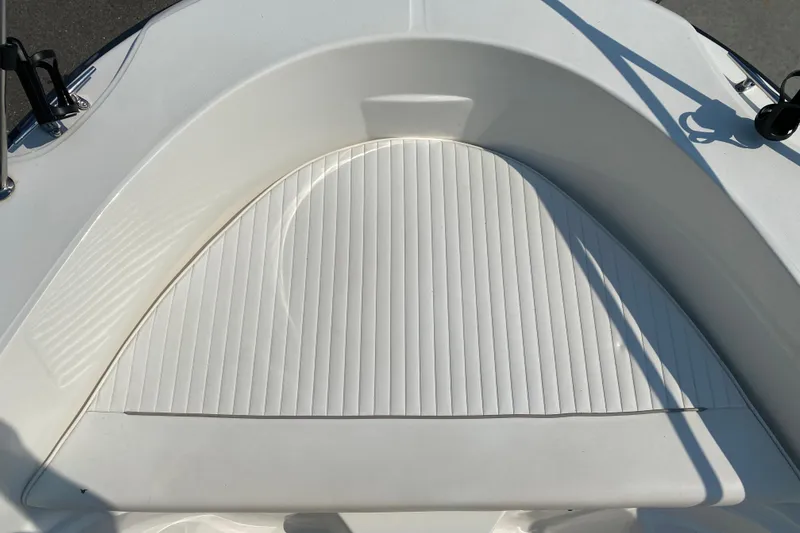 Slide: The Image of 2001 Boston Whaler 18 Dauntless boat interior, featuring a white cushioned seating area. - 12