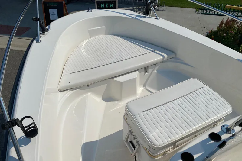 Slide: The Image of 2001 Boston Whaler 18 Dauntless boat interior with cushioned seating and storage. - 13