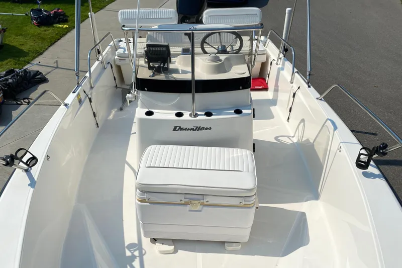 Slide: The Image of 2001 Boston Whaler 18 Dauntless boat interior with seating and steering console. - 16