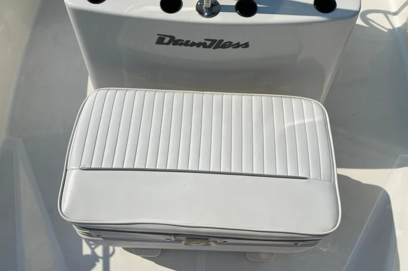 Slide: The Image of 2001 Boston Whaler 18 Dauntless boat seat with white cushioned upholstery. - 17