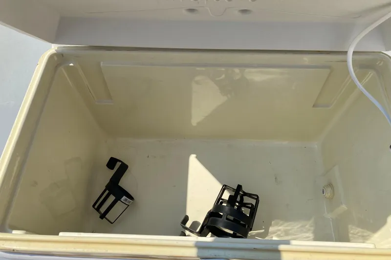 Slide: The Image of Open storage compartment on 2001 Boston Whaler 18 Dauntless boat with cup holders inside. - 18