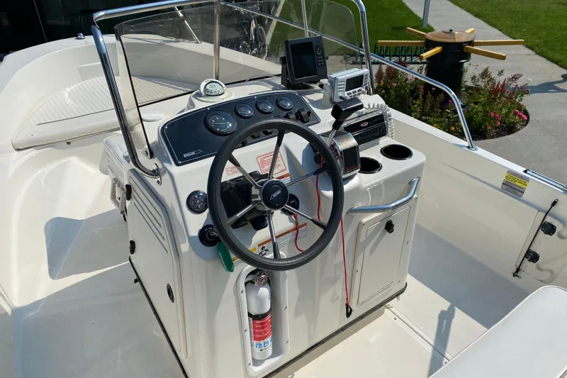 Slide: The Image of 2001 Boston Whaler 18 Dauntless boat console with steering wheel and navigation equipment. - 20