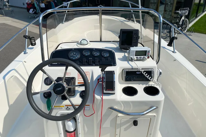 Slide: The Image of 2001 Boston Whaler 18 Dauntless boat console with steering wheel and navigation equipment. - 21